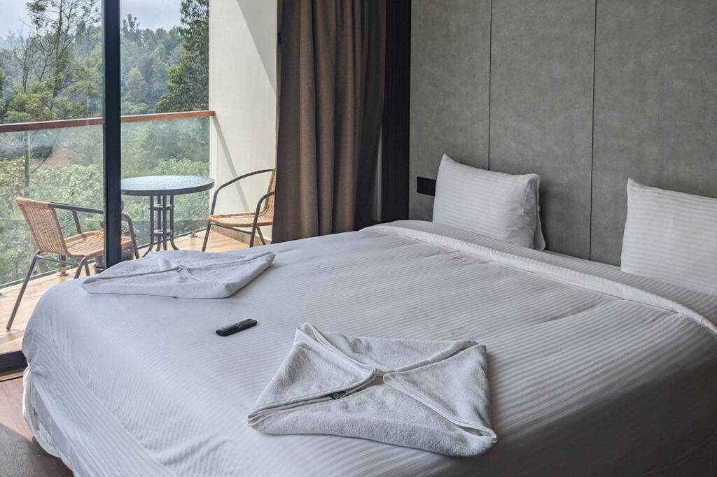 Luxury homestay Ooty Homz with glass-walled rooms offering panoramic tea estate views, nestled in serene surroundings, perfect for a tranquil getaway